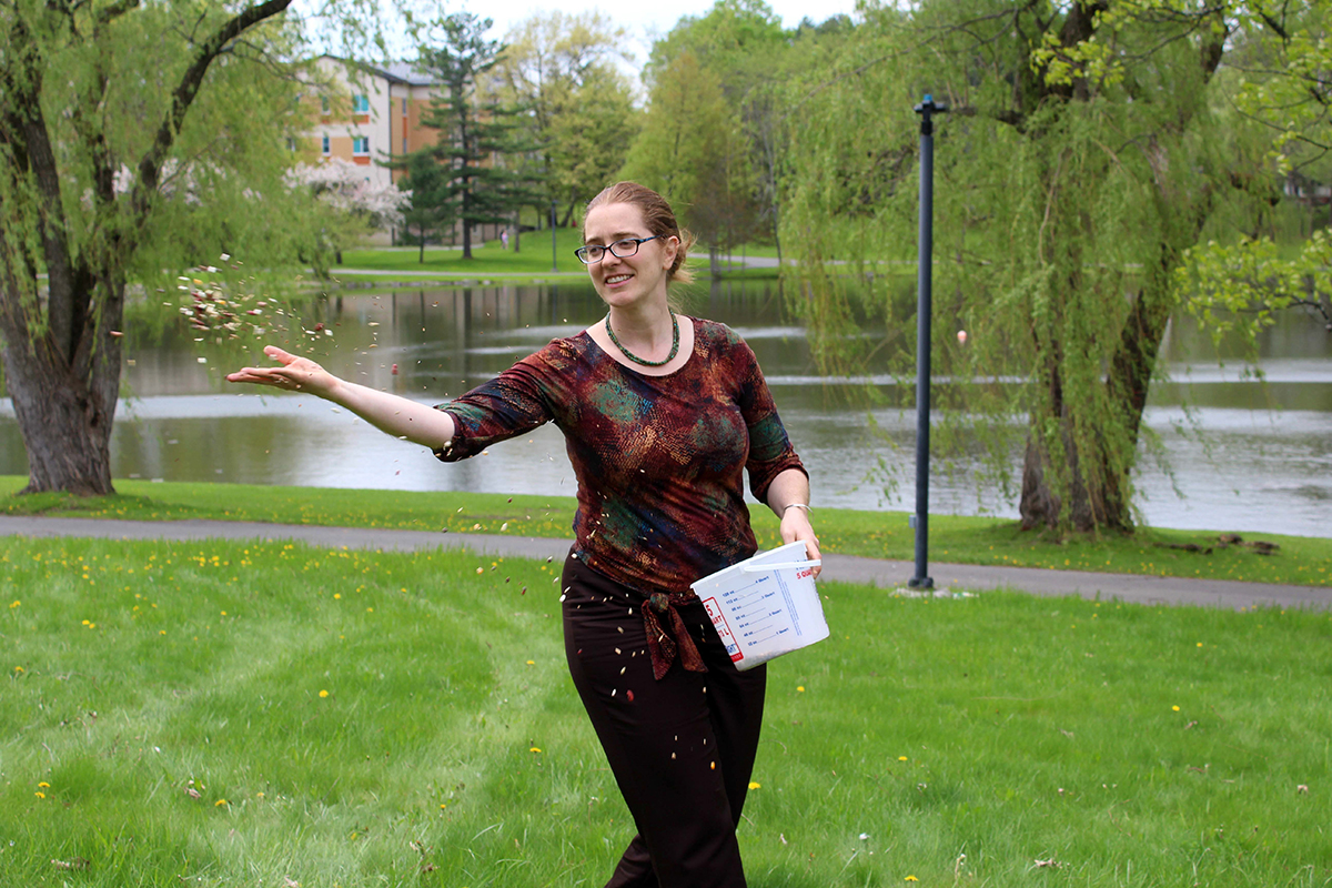 faculty member throwing seeds